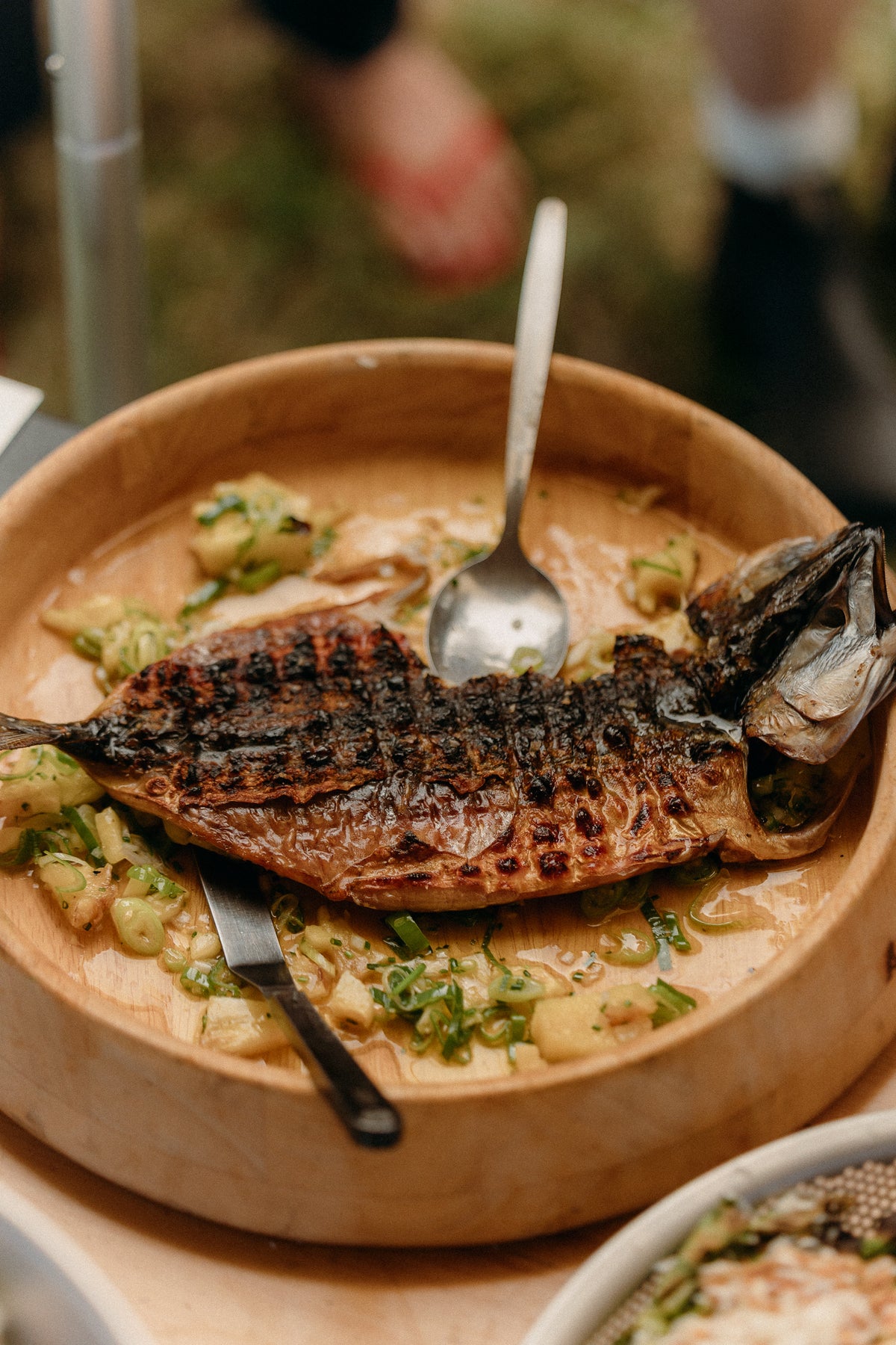 Chef Ivan Tisdall-Downes cooking on the Takibi Fire & Grill at the Snow Peak Way