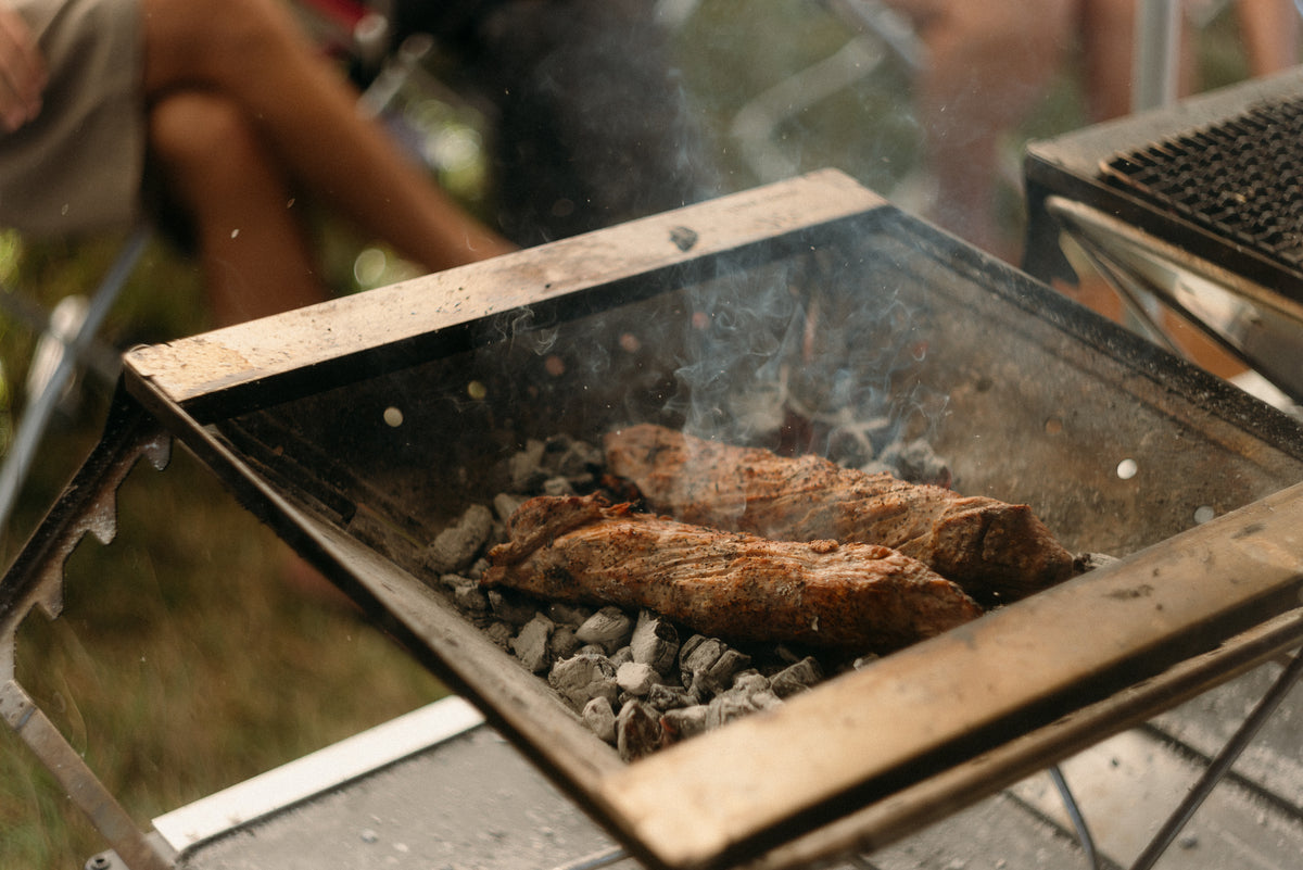 Chef Ivan Tisdall-Downes cooking on the Takibi Fire & Grill at the Snow Peak Way