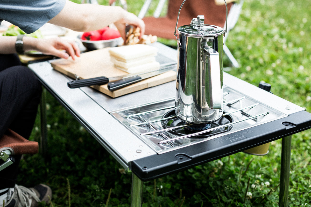 Cooking and preparing food around a Snow Peak Iron Grill Table