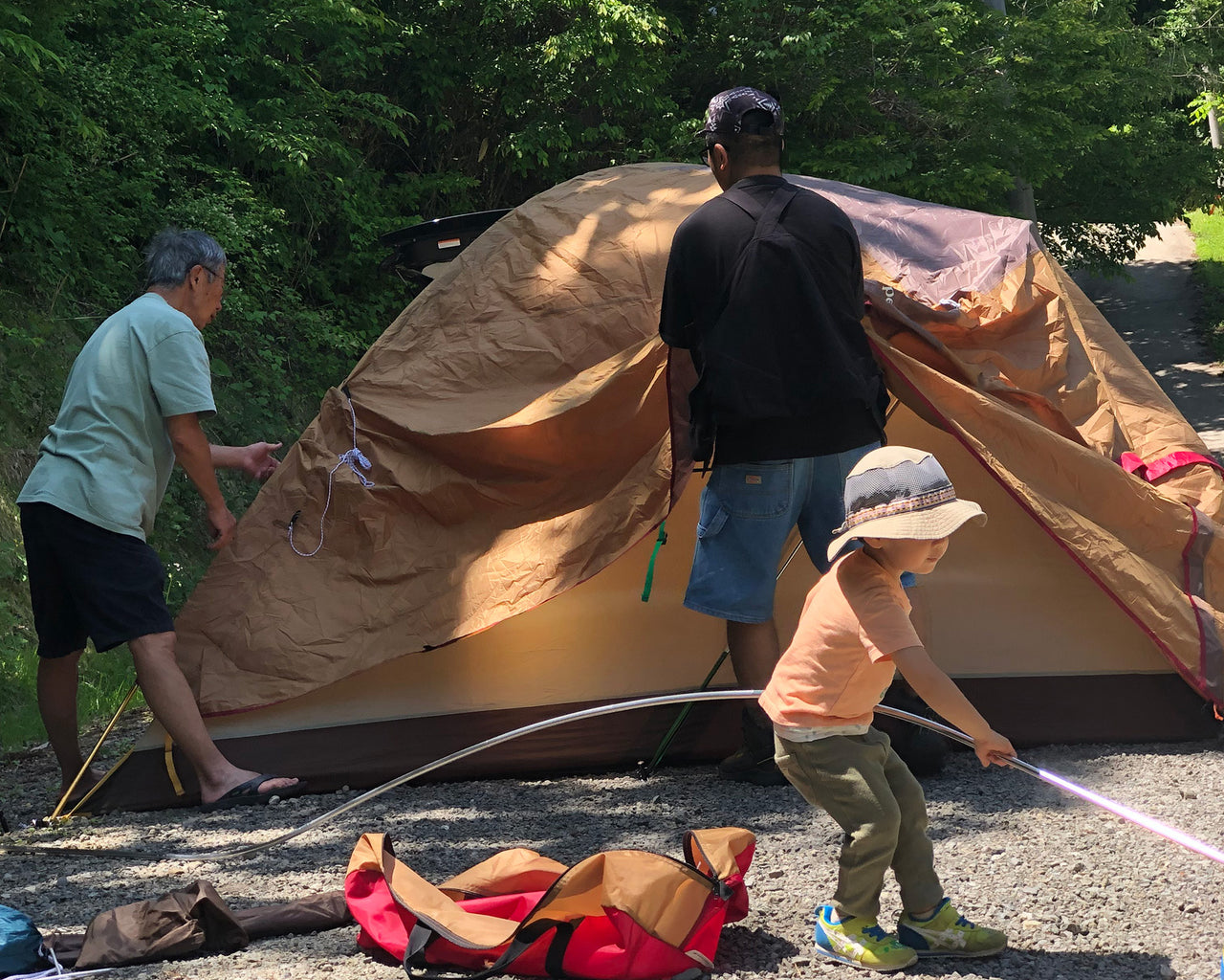 Young child helping to set up a tent